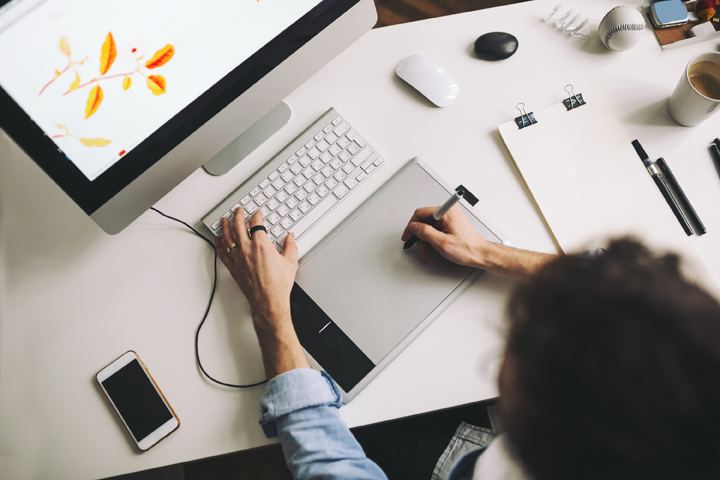 Young graphic designer working in office